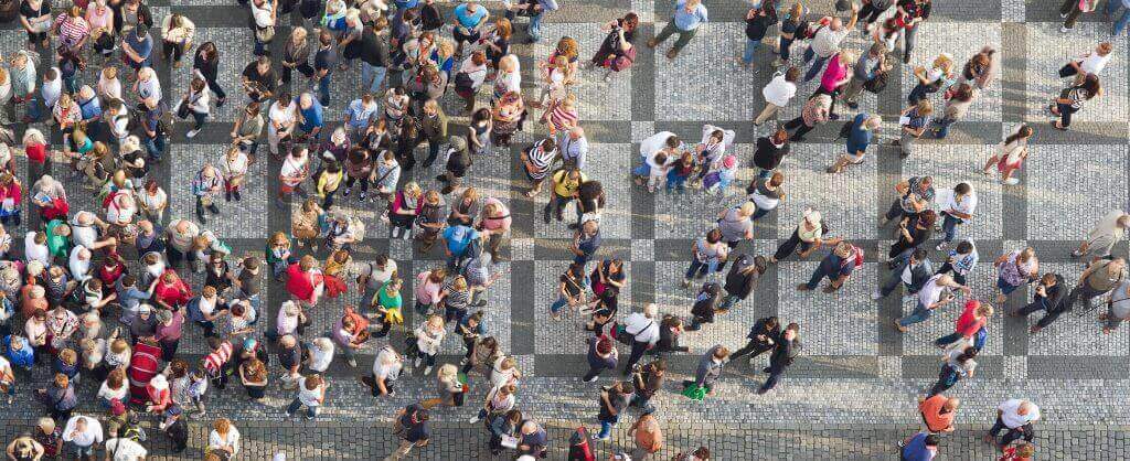 People walking on patterned brick sidewalk